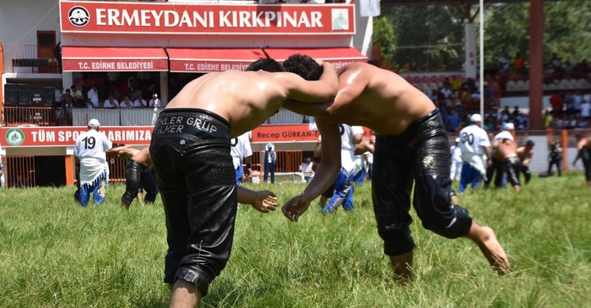 Two wrestlers try to put each other's back to the ground in one of many matches held on Friday in Ku0131rkpu0131nar, July 5, 2019.
