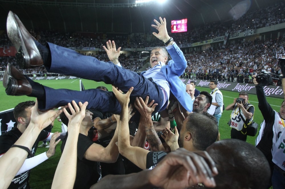 Beu015fiktau015f players and head coach u015eenol Gu00fcneu015f celebrate winning the Super League championship.