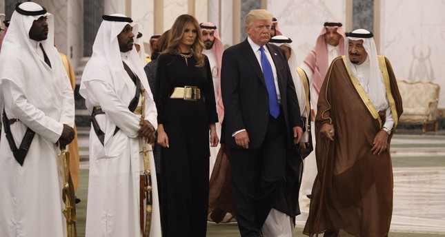 President Trump and first lady Melania Trump walk with Saudi King Salman to a presentation ceremony at the Royal Court Palace, Riyadh, May 20.