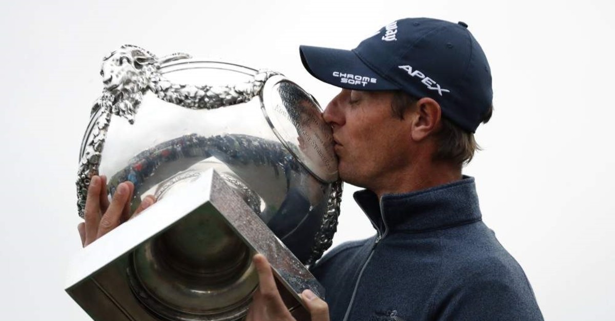 Nicolas Colsaerts of Belgium kisses the trophy after winning the Amundi French Open, at Le Golf National in Saint-Quentin-en-Yvelines, outside Paris, France, Sunday, Oct. 20, 2019. (AP Photo/Thibault Camus)