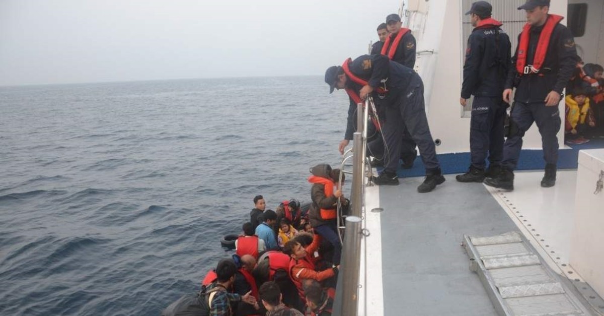 The Turkish Coast Guard pulls migrants into their boat in this undated photo taken off the western coast of Bal?kesir province. (?HA Photo)