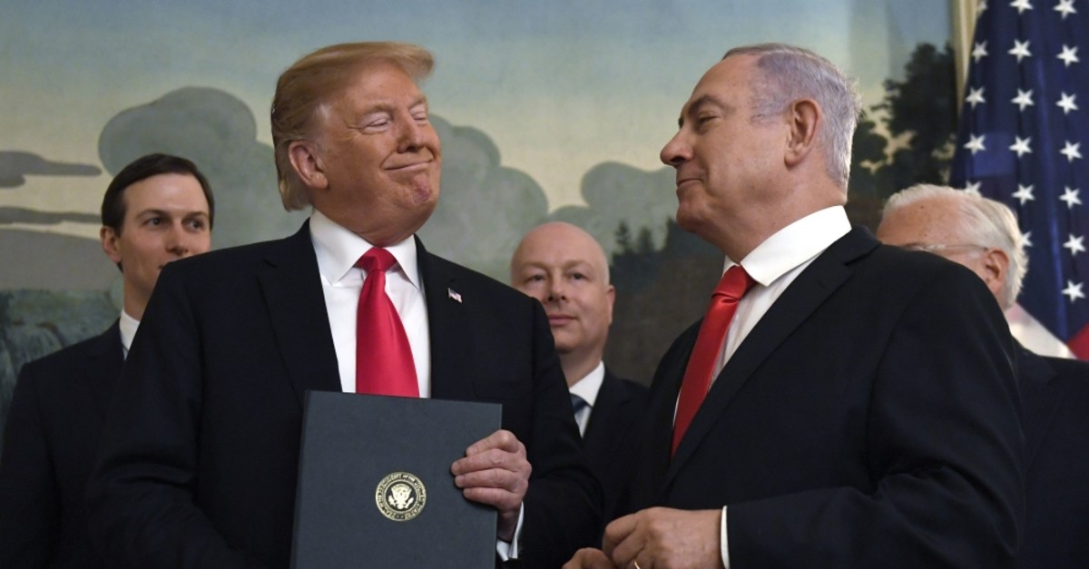 U.S. President Donald Trump smiles at Israeli Prime Minister Benjamin Netanyahu, Washington, D.C., March 25, 2019.