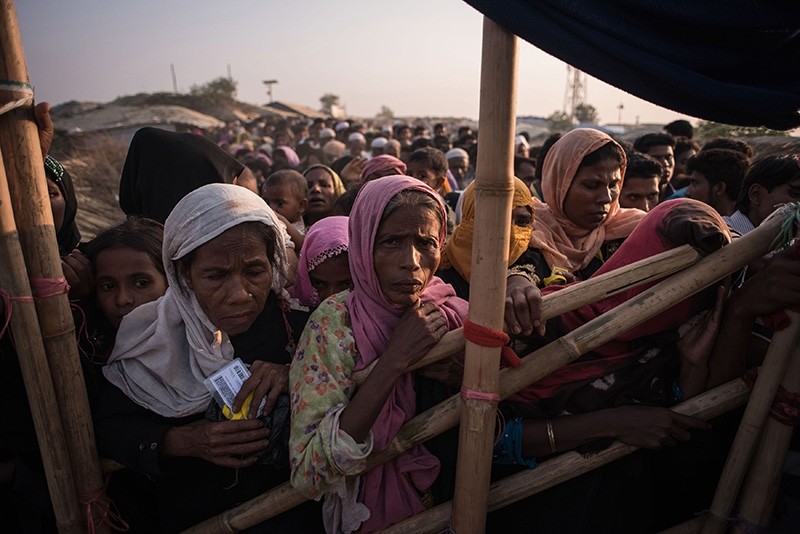 In this file photo taken on November 28, 2017, Rohingya Muslim refugees wait to be called to receive food aid of rice, water and cooking oil in a relief centre at the Kutupalong refugee camp in Cox's Bazar. (AFP Photo)