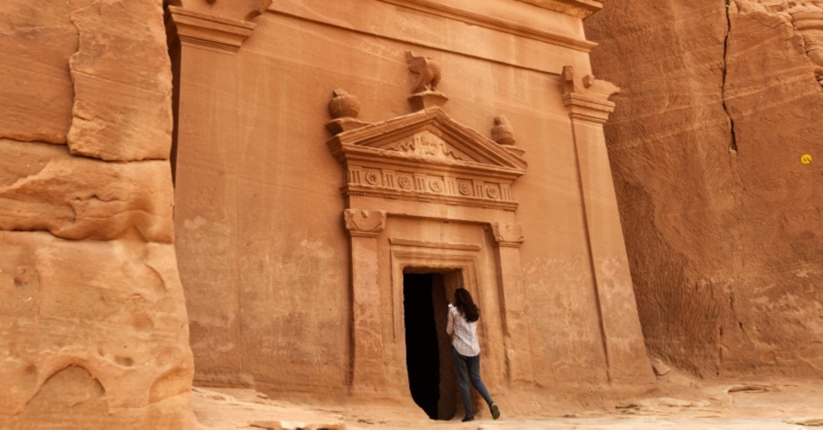 In this file photo taken on March 31, 2018 a journalist takes a photo of a tomb at Madain Saleh, a UNESCO World Heritage site, near Saudi Arabia's northwestern town of al-Ula. (AFP Photo)