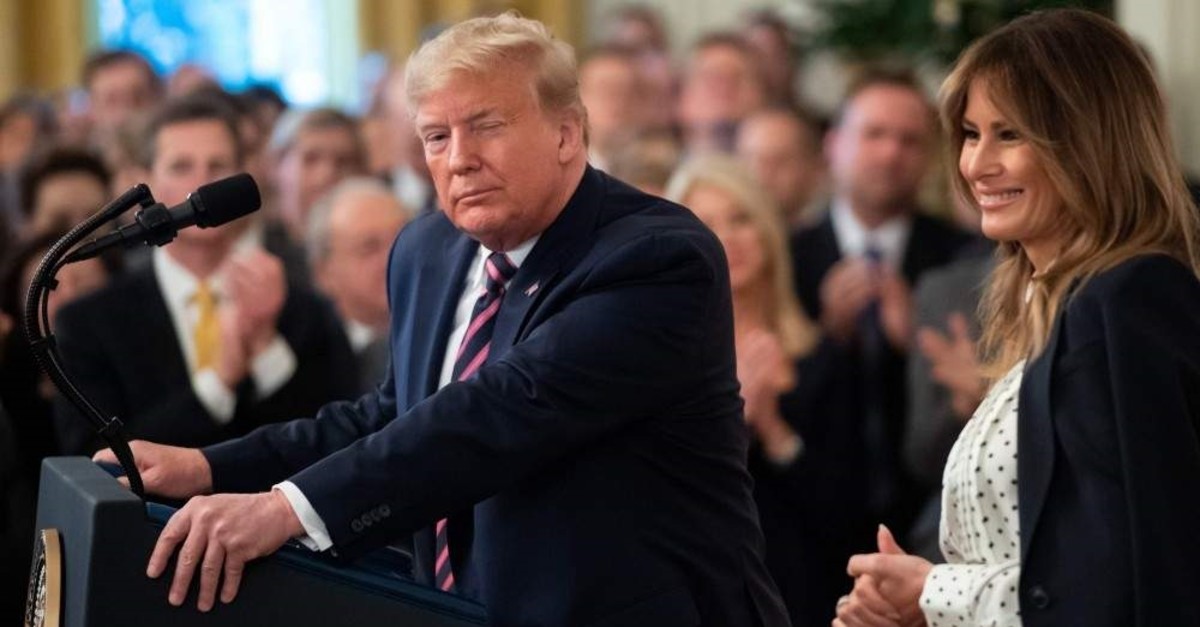 U.S. President Donald Trump winks alongside first lady Melania Trump as he speaks about his Senate impeachment trial in the East Room of the White House, Washington, D.C., Feb. 6, 2020. (AFP Photo)