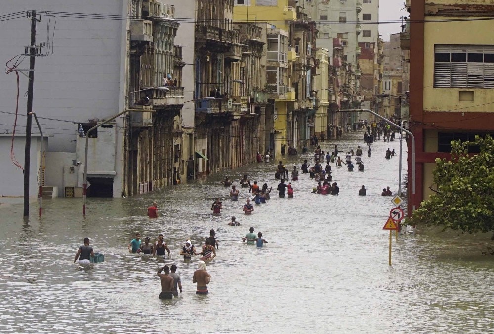 People move through flooded streets in Havana after the passage of Hurricane Irma, in Cuba.