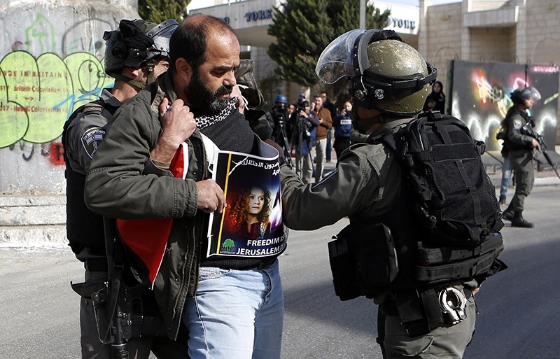 Israeli border police forcefully detain a Palestinian demonstrator in the West Bank city of Bethlehem. (EPA Photo)