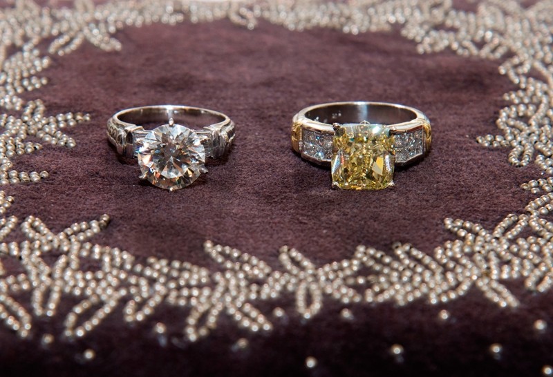 A 4.5 carat brilliant round-cut diamond in solid platinum band, estimated at USD $275,000 (left) and a 4.15 carat natural fancy yellow cushion-cut diamond ring in solid platinum band (right) estimated at USD $325,000 ( AFP Photo)
