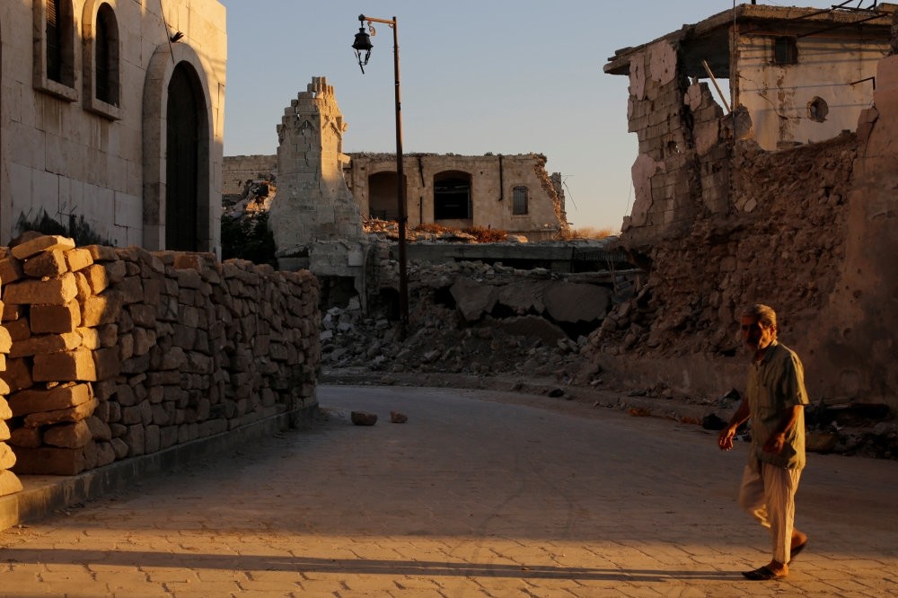 A man walks past damaged buildings in the old city of Aleppo, Syria, July 16. 