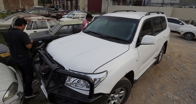 Pakistani journalists examine a car of American diplomate parked inside a police station after an accident in Islamabad, Pakistan, Saturday, April 7, 2018. (AP Photo)