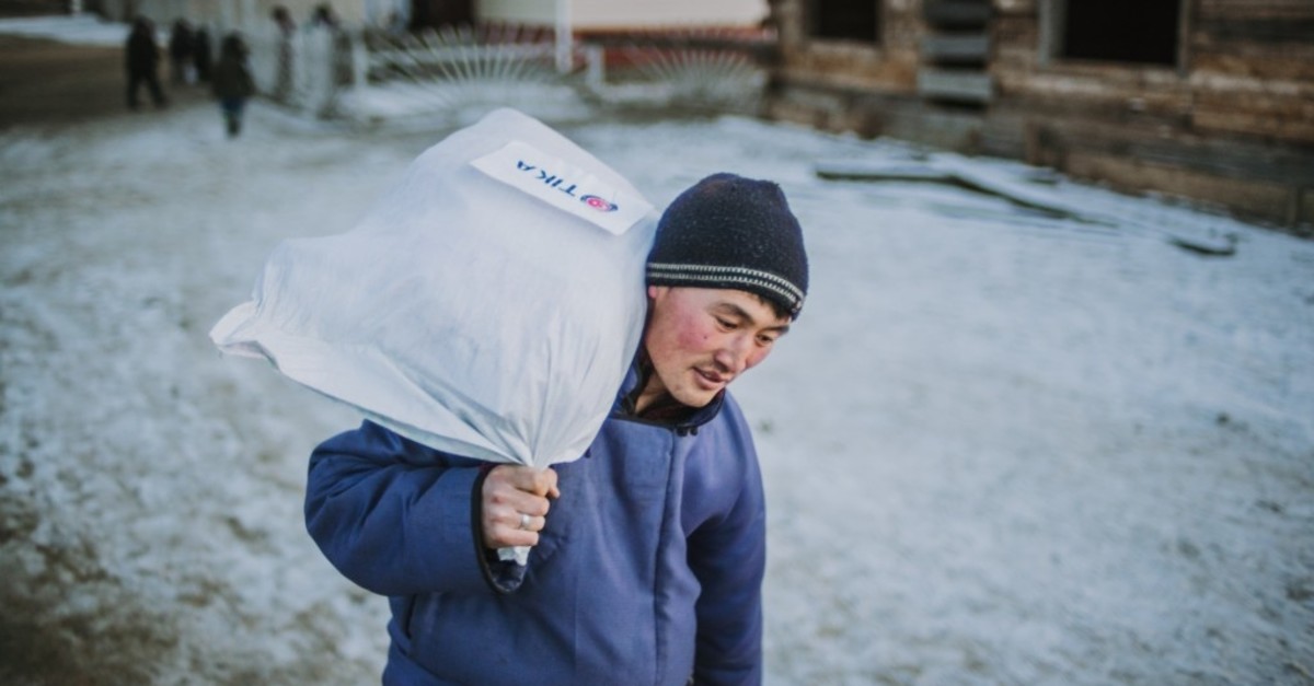 A member of the Dukha community carries an aid package donated by Tu0130KA in Tsaganur, Mongolia, March 2019.