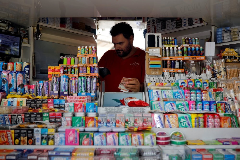 Kiosk owner Christos Papageorgiou, 43, is seen inside his kiosk in Athens, Greece.