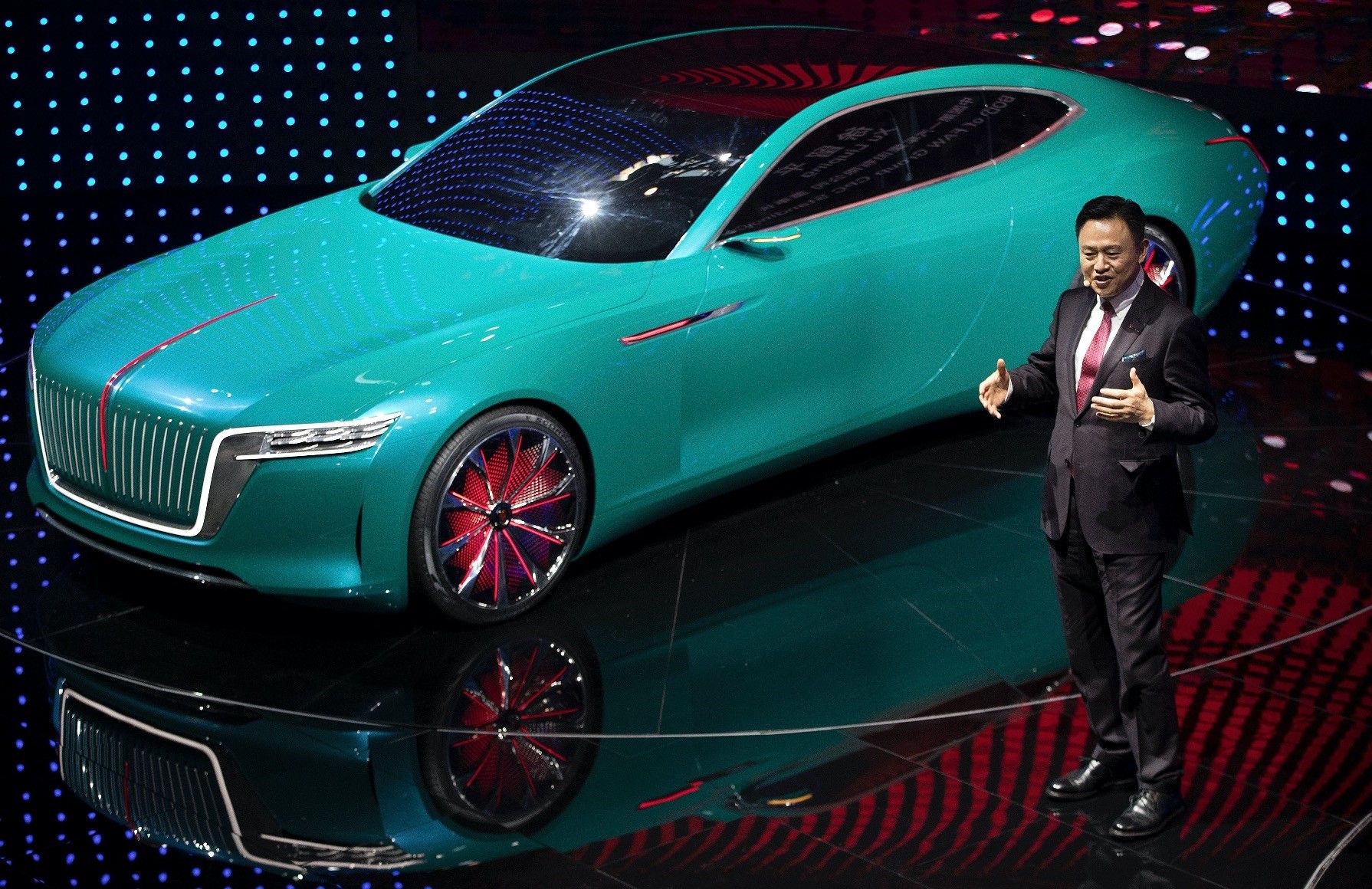 ...state-owned FAW Group, speaks after presenting the Hongqi E-Jing GT elec...