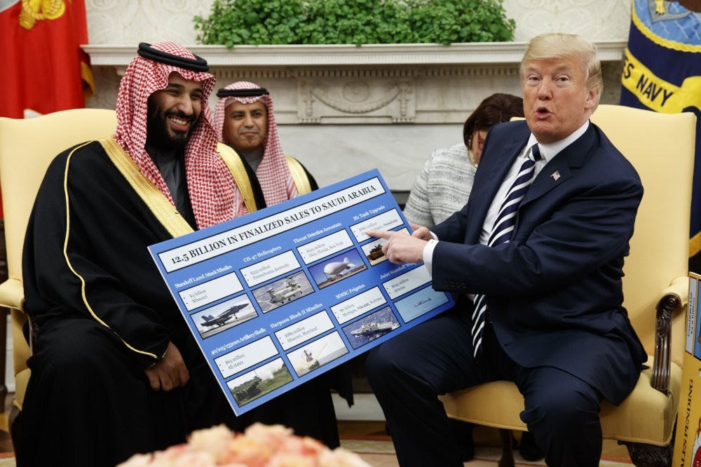 U.S. President Donald Trump shows a chart about arms sales to Saudi Arabia, during a meeting with Crown Prince Mohammed bin Salman at the White House, Washington, D.C., March 20, 2018.