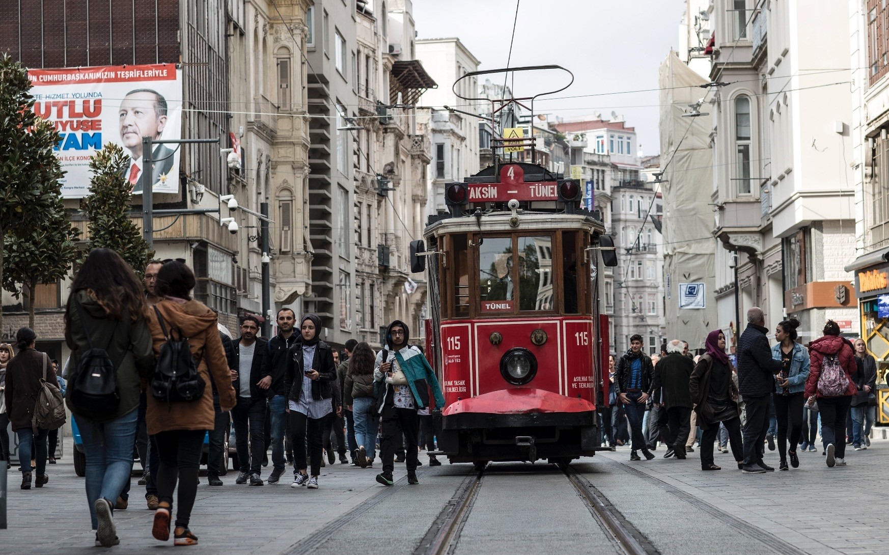 People walk next to the nostalgic tram on u0130stiklal Avenue, Istanbul, April 18.