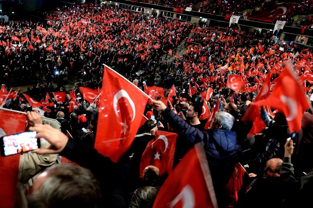 Participants waving Turkish flags at a meeting on the April referendum, held by Prime Minister Binali Yu0131lu0131ru0131m in Oberhausen, Germany, Feb. 18.