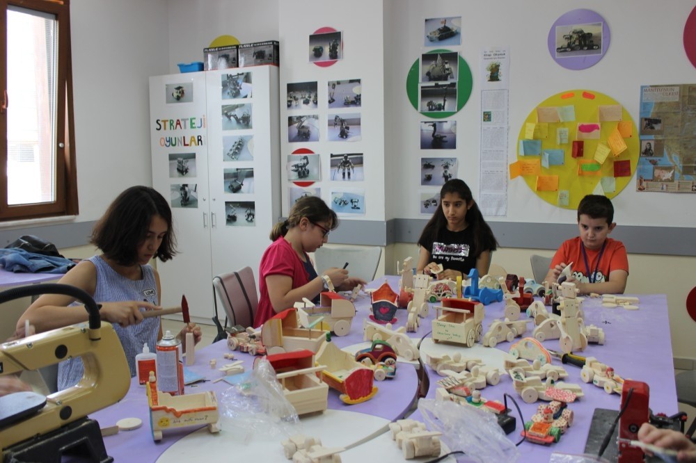 From cradles to cars, children build and paint wooden toys at the workshop.