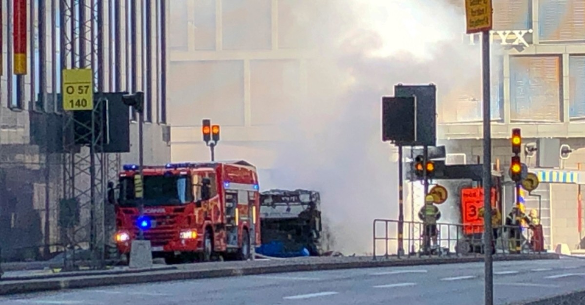An emergency vehicle stands in front of the bus that exploded and caught fire in central Stockholm, Sweden on Sunday March 10, 2019 (AP Photo)