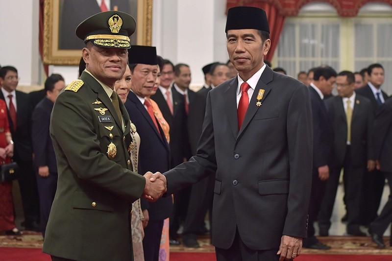 Indonesia's Military Chief General Gatot Nurmantyo (L) shakes hands with Indonesia's President Joko Widodo after the swearing-in ceremony at the presidential palace in Jakarta. (AFP File Photo)