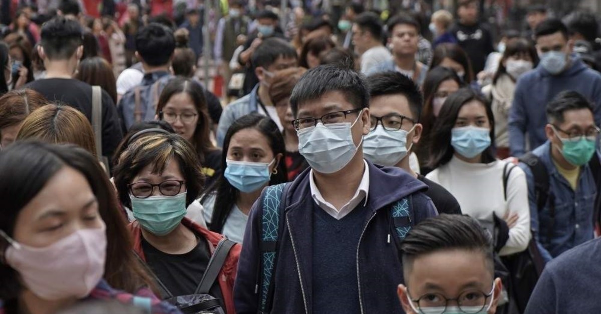 People wear masks on a street, Hong Kong, Jan. 24, 2020. (AP Photo)