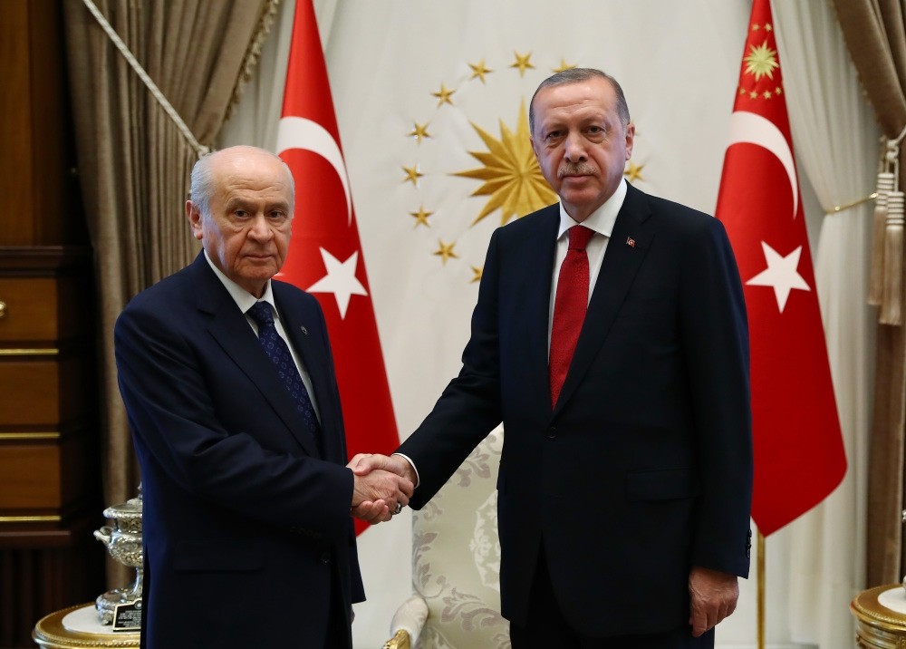 President Recep Tayyip Erdou011fan shakes hands with MHP Chairman Devlet Bahu00e7eli (L).