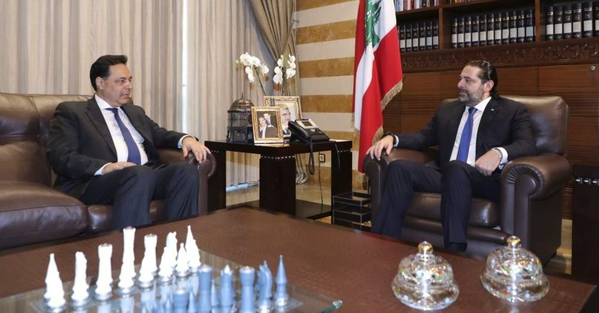 Lebanese prime minister-designate Hassan Diab (L) meets with outgoing Prime Minister Saad Hariri, Beirut, Dec. 20, 2019. (AP Photo)