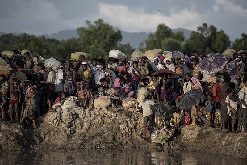 In this file photo taken on Oct. 9, 2017, Rohingya refugees wait after crossing the Naf river from Myanmar into Bangladesh in Whaikhyang. (AFP Photo)