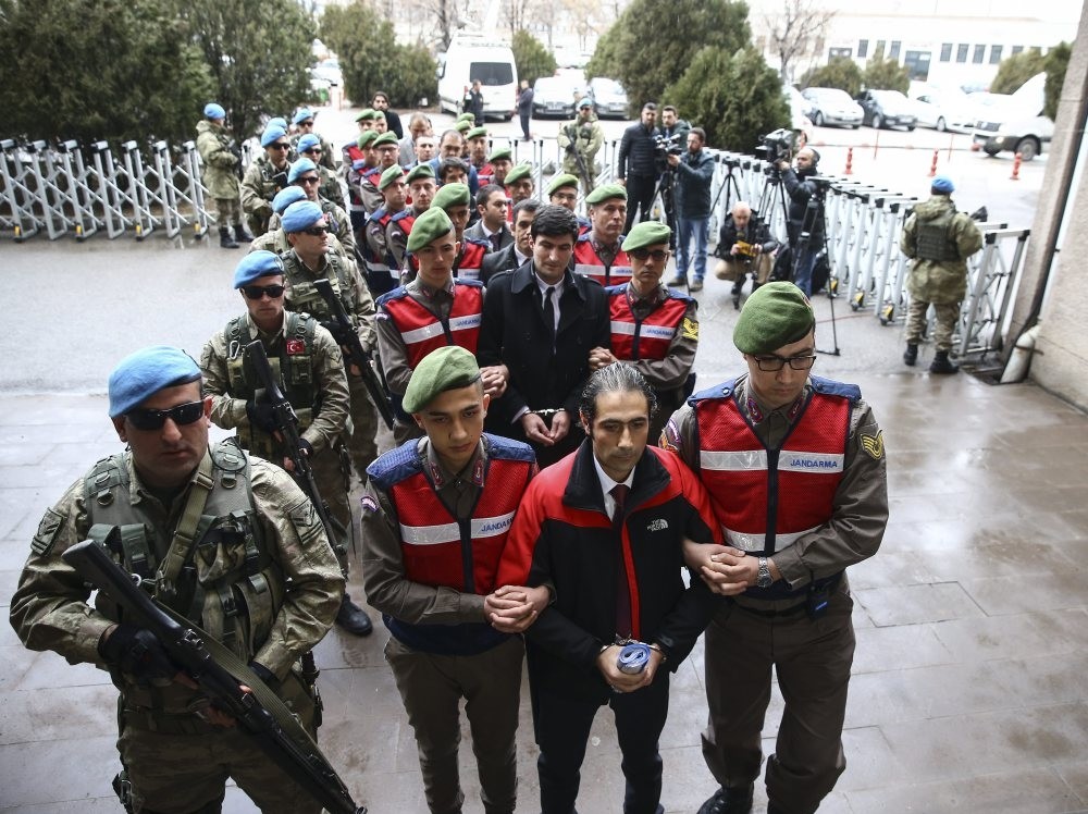 Soldiers escort Maj. Fatih u015eahin (center) to the courtroom in yesterday's hearing. u015eahin was the officer who fired first shot at u00d6mer Halisdemir, a heroic anti-coup officer.