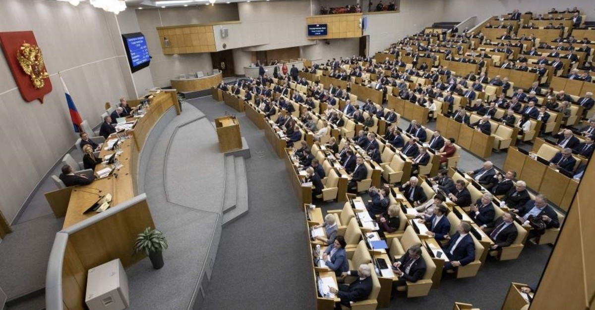 Russian lawmakers vote for Russian constitutional amendments during a session at the Russian State Duma, the Lower House of the Russian Parliament, Moscow, Jan. 23, 2020. (AP Photo)