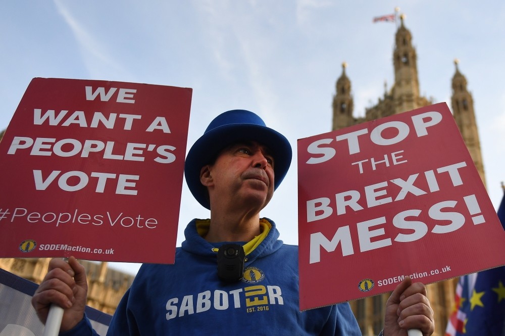 Pro-EU protesters demonstrate outside Parliament calling for a people's vote in London, yesterday.