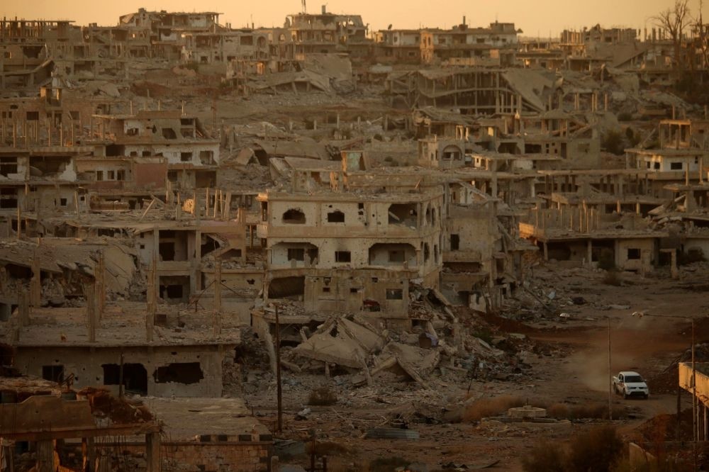 A truck drives through a damaged street in an opposition-held area in Daraa, southern Syria, Nov. 16.