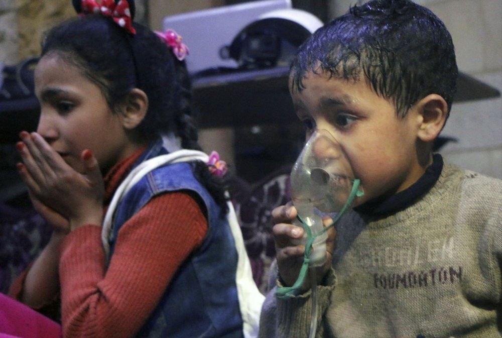 A child receives oxygen through a respirator taken in Douma, April 8.