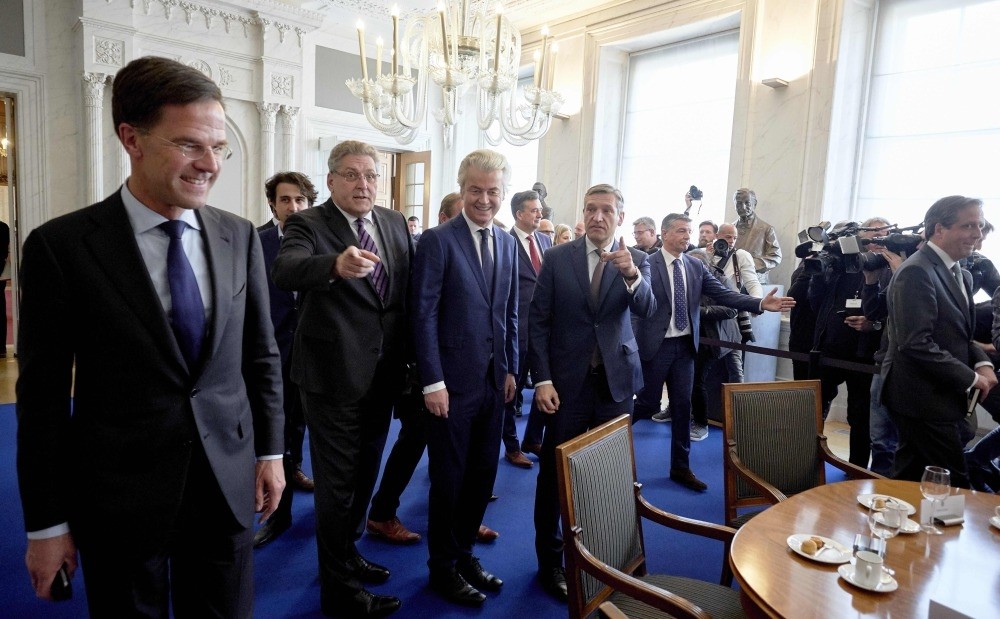 Dutch PVV leader Geert Wilders (C) and Dutch Prime Minister Mark Rutte (L) arrives for a meeting between main parties leaders and the Chairman of the Senate in The Hague, on March 16, 2017, one day after the general elections.