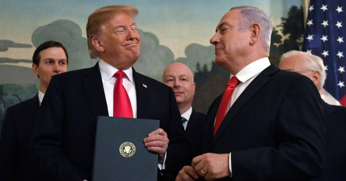 President Donald Trump smiles at Israeli Prime Minister Benjamin Netanyahu after signing a proclamation at the White House in Washington, March 25, 2019. (AP Photo)