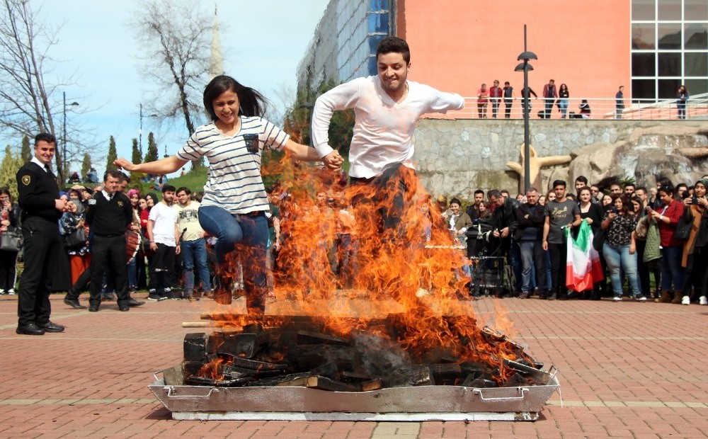 People jump over a bonfire in a Nevruz celebration in the northern city of Zonguldak.