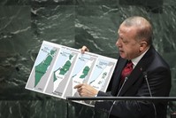 President Recep Tayyip Erdou011fan holds up a map of Palestine since 1947 showing changing population and territory under Israeli rule while speaking at U.N. headquarters in New York, Sept. 24, 2019