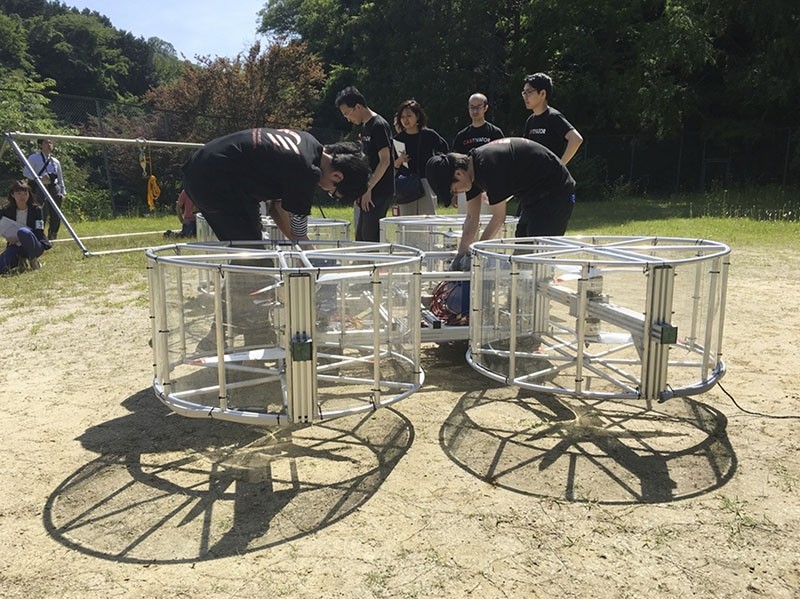 Cartivator members prepare for a test flight of their flying car model on a former school ground in Toyota, central Japan. (AP Photo)