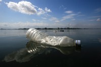A plastic bottle floats on the Ebrie Lagoon in the city of Abidjan, Ivory Coast.