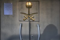 The shadow of a security member is seen on the door of the Saudi Arabian Consulate in Istanbul, Oct. 29, 2018, while the investigation into the murder of Saudi journalist Jamal Khashoggi is underway. 