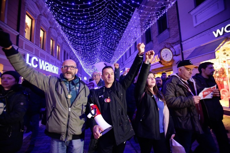 Davor Dragicevic, second left, walks during a peaceful protest march in the Bosnian town of Banja Luka, 240 kms northwest of Sarajevo, Bosnia, on Wednesday, Dec. 26, 2018.
