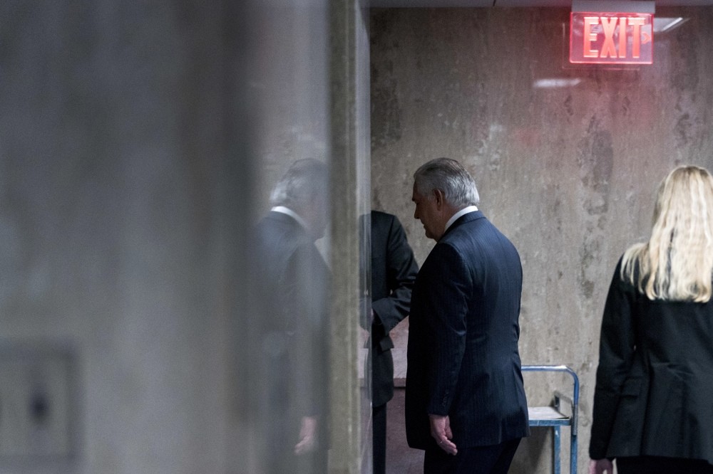 Recenty sacked U.S. Secretary of State Rex Tillerson walks down a hallway after speaking at a news conference at the State Department in Washington, March 13.