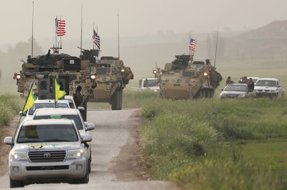 The YPG terrorists heading a convoy of U.S military vehicles in the Syrian town of Darbasiya next to the Turkish border, April 28. 