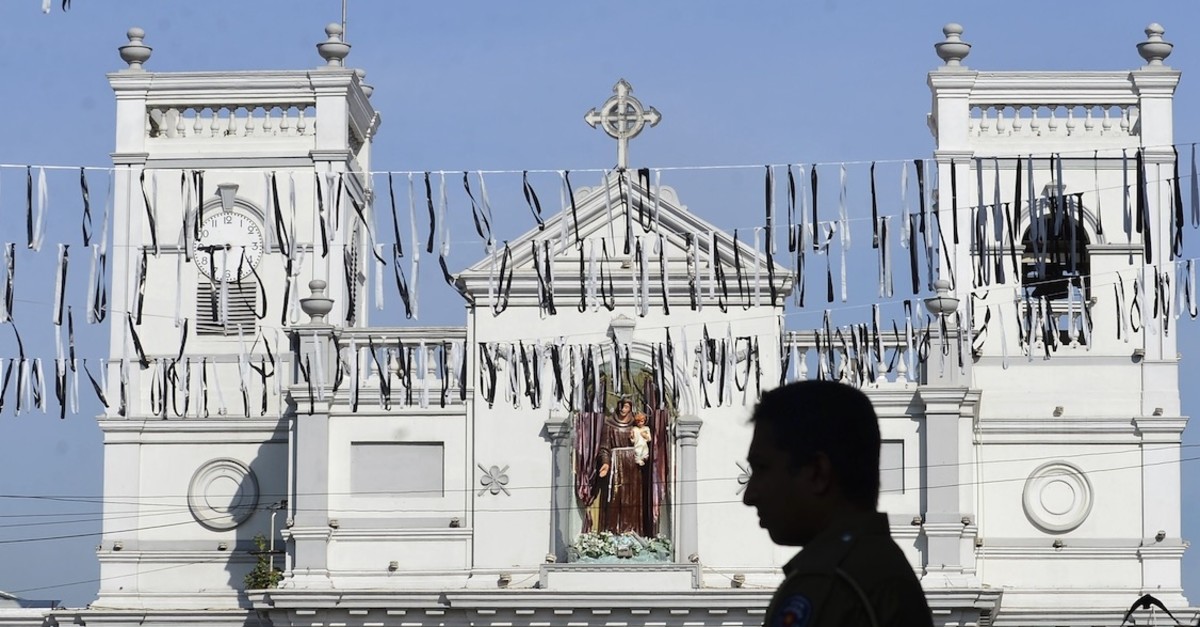 A Sri Lankan man stands still during moments of silence outside St. Anthonyu2019s Shrine, Colombo, April 23, 2019.
