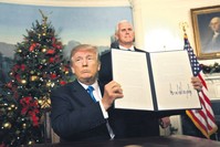 U.S. Vice President Mike Pence (R) watches as President Trump holds up his proclamation about his controversialdecision to recognize Jerusalem as the capital of Israel, at the White House, Washington, Dec. 6. 