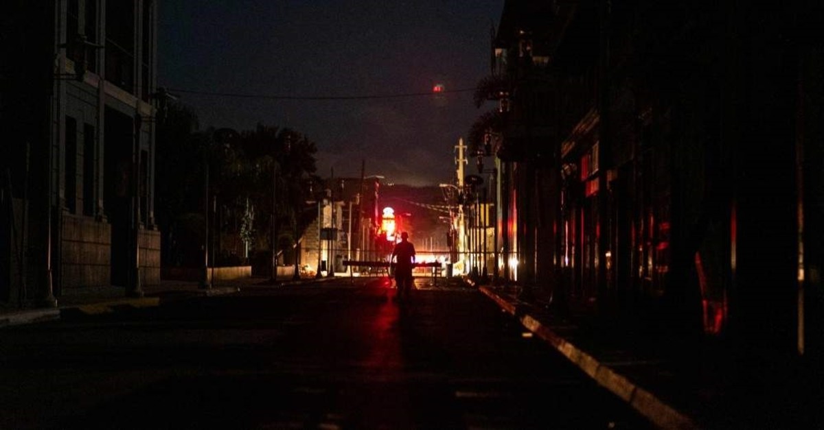 A man walks on a dark street after an earthquake hit the island in Guanica, Puerto Rico on January 8, 2020. (AFP Photo)