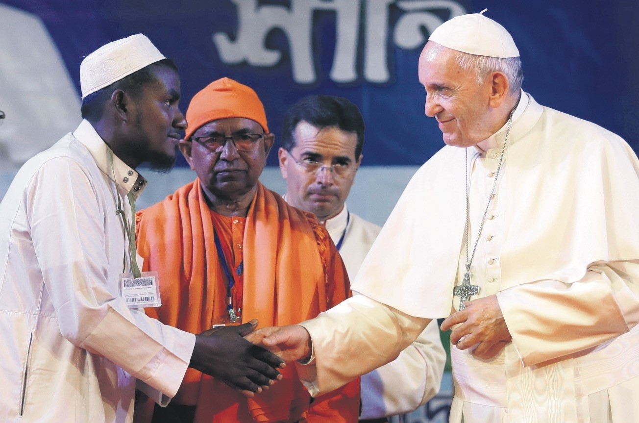 Pope Francis (R) shakes hands with a Rohingya Muslim refugee during an interfaith and ecumenical meeting for peace in the garden of the archbishop's residence, in Dhaka, Bangladesh.