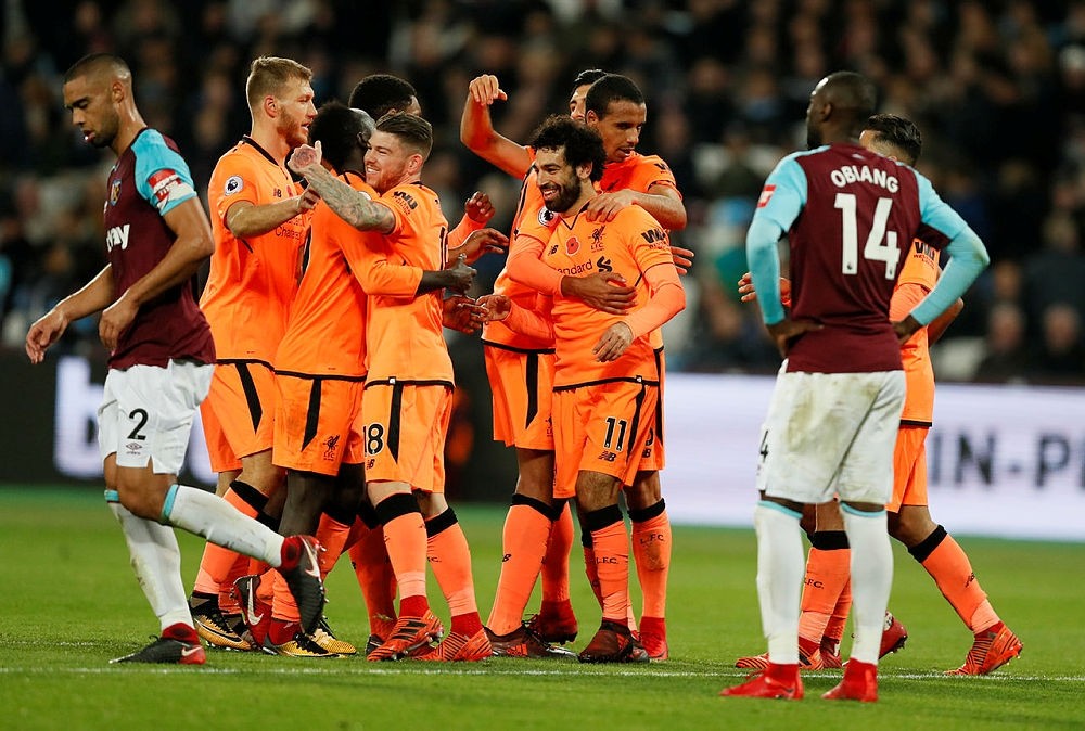 Liverpool's Mohamed Salah celebrates with teammates after scoring his side's fourth goal past West Ham in London, Saturday, Nov. 4, 2017. (AP Photo)