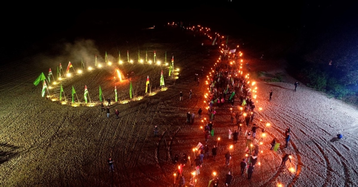 People carrying torches and flags mark the 155 anniversary of the expulsion of Circassians from the Caucasus at a beach in Kandu0131ra district of northwestern Turkey's Kocaeli province, May 18, 2019. (Sabah Photo)