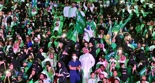 In this Sept. 23, 2017 file photo released by Saudi Press Agency, SPA, Saudi men and wom en attend national day ceremonies at the King Fahd stadium in Riyadh, Saudi Arabia (AP File Photo)