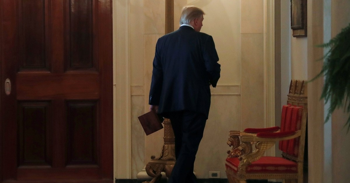 U.S. President Donald Trump walks down a hallway after hosting an event after the release of Special Counsel Robert Muelleru2019s report, in the White House in Washington D.C., April 18, 2019.